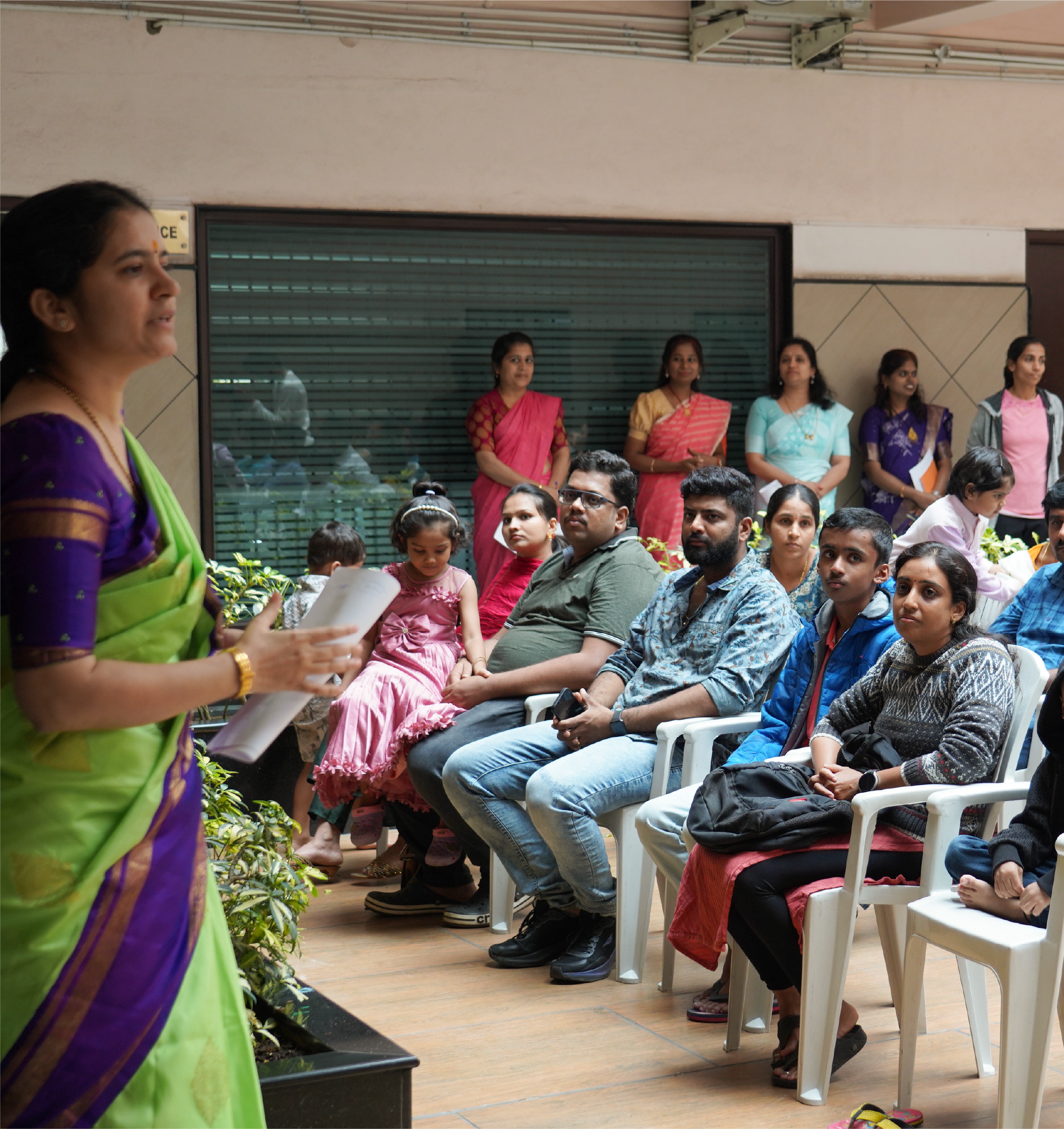 Teacher addressing group of parents and children